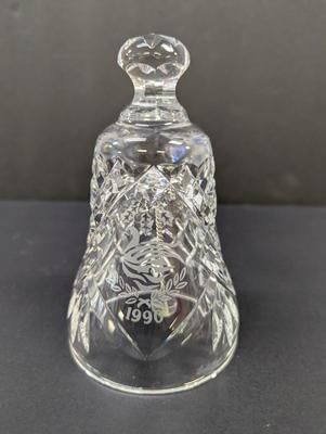 Sale Photo Thumbnail #317: The Waterford Crystal Collectors 1990 Bell features a theme of bells with a unique design of seven swans swimming. Made of high-quality crystal, this collectible item captures the essence of the 12 Days of Christmas. With its intricate details and timeles