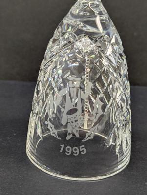 Sale Photo Thumbnail #331: The Waterford Crystal Collectors 1995 Bell is a beautifully crafted decorative piece featuring 12 drummers drumming on Christmas Day. Made of high-quality crystal, this bell captures the festive spirit of the holiday season. With its intricate design and 