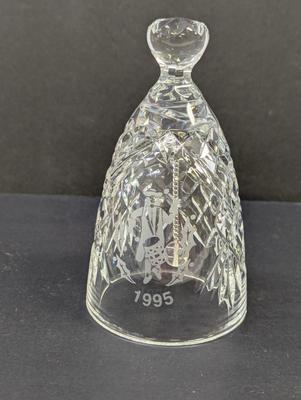 Sale Photo Thumbnail #330: The Waterford Crystal Collectors 1995 Bell is a beautifully crafted decorative piece featuring 12 drummers drumming on Christmas Day. Made of high-quality crystal, this bell captures the festive spirit of the holiday season. With its intricate design and 