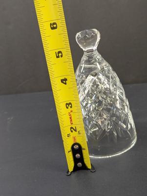 Sale Photo Thumbnail #334: The Waterford Crystal Collectors 1995 Bell is a beautifully crafted decorative piece featuring 12 drummers drumming on Christmas Day. Made of high-quality crystal, this bell captures the festive spirit of the holiday season. With its intricate design and 