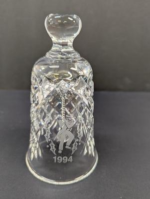 Sale Photo Thumbnail #335: The Waterford Crystal Collectors 1994 Bell is a beautifully crafted Christmas-themed bell made of crystal. With a classic Christmas theme of 12 days of Christmas and 11 pipers piping, this bell is a perfect addition to any collector's display. The intrica