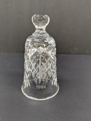 Sale Photo Thumbnail #338: The Waterford Crystal Collectors 1994 Bell is a beautifully crafted Christmas-themed bell made of crystal. With a classic Christmas theme of 12 days of Christmas and 11 pipers piping, this bell is a perfect addition to any collector's display. The intrica
