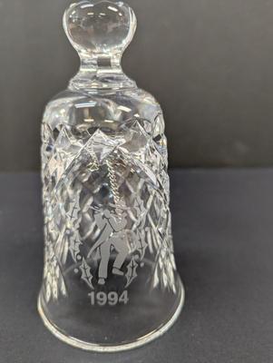 Sale Photo Thumbnail #336: The Waterford Crystal Collectors 1994 Bell is a beautifully crafted Christmas-themed bell made of crystal. With a classic Christmas theme of 12 days of Christmas and 11 pipers piping, this bell is a perfect addition to any collector's display. The intrica