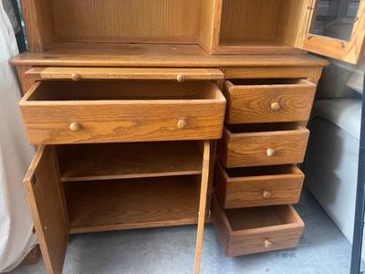 Sale Photo Thumbnail #896: Tall Wooden Hutch with Glass Inserts. Glass is removable, doors have magnetic closures. Plus an extra pull out serving surface. Huge amount of storage. Some sun bleaching on the upper cabinets and missing some of the magnetic closures, but otherwise good 
