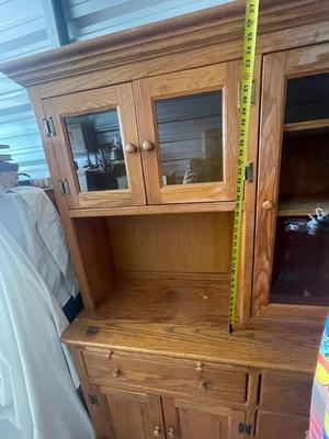 Sale Photo Thumbnail #903: Tall Wooden Hutch with Glass Inserts. Glass is removable, doors have magnetic closures. Plus an extra pull out serving surface. Huge amount of storage. Some sun bleaching on the upper cabinets and missing some of the magnetic closures, but otherwise good 