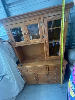Sale Photo Thumbnail #901: Tall Wooden Hutch with Glass Inserts. Glass is removable, doors have magnetic closures. Plus an extra pull out serving surface. Huge amount of storage. Some sun bleaching on the upper cabinets and missing some of the magnetic closures, but otherwise good 