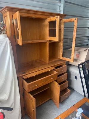 Sale Photo Thumbnail #894: Tall Wooden Hutch with Glass Inserts. Glass is removable, doors have magnetic closures. Plus an extra pull out serving surface. Huge amount of storage. Some sun bleaching on the upper cabinets and missing some of the magnetic closures, but otherwise good 
