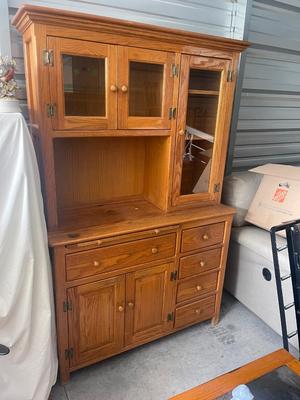 Sale Photo Thumbnail #893: Tall Wooden Hutch with Glass Inserts. Glass is removable, doors have magnetic closures. Plus an extra pull out serving surface. Huge amount of storage. Some sun bleaching on the upper cabinets and missing some of the magnetic closures, but otherwise good 