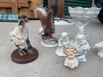 Sale Photo Thumbnail #918: Anatomically Incorrect Statuettes (Lot of 8). Wall mounted wolf, several porcelain cherubs, biker bobblehead, and an eagle.
