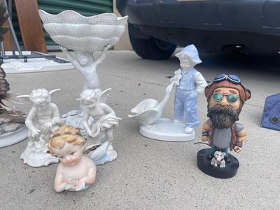 Sale Photo Thumbnail #917: Anatomically Incorrect Statuettes (Lot of 8). Wall mounted wolf, several porcelain cherubs, biker bobblehead, and an eagle.