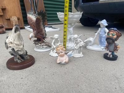 Sale Photo Thumbnail #927: Anatomically Incorrect Statuettes (Lot of 8). Wall mounted wolf, several porcelain cherubs, biker bobblehead, and an eagle.