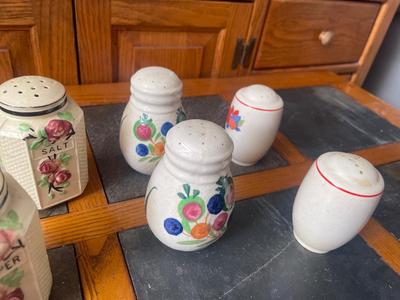 Sale Photo Thumbnail #953: Lot of Antique Salt and Pepper Shakers (Lot of 6). 3 sets, each with painted details on the sides. Removable plug in the bottom of each shaker.