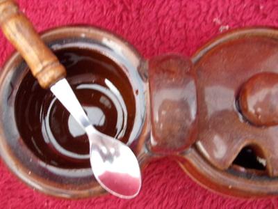 A group of sugar bowls and a creamer.