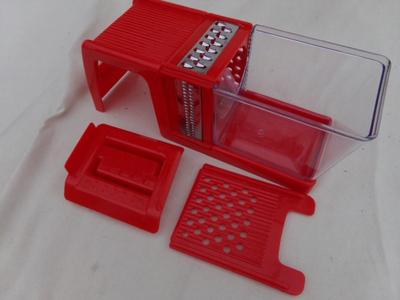 MULTIGRATER food grater-slicer-dicer do it all tool. Looks like NEW/unused in original Box.