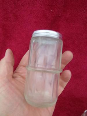 Group of 4 small spice & seasoning bottles w/twist-on lids.