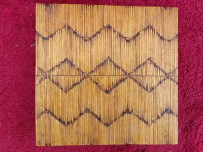A pair of craft made trivets. Each about 7" square. Tops made of match sticks