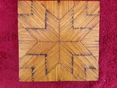 A pair of craft made trivets. Each about 7" square. Tops made of match sticks