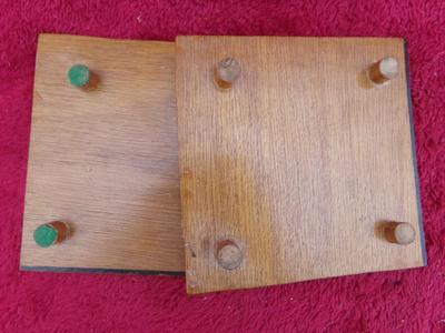 A pair of craft made trivets. Each about 7" square. Tops made of match sticks