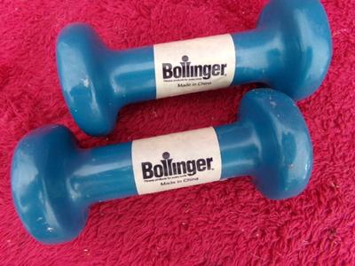 A pair of little 2 lb. exercise dumbbells that appear like new/unused.