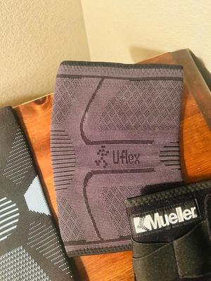 A VARIETY OF KNEE BRACES AND HAND WEIGHTS