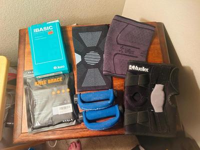 A VARIETY OF KNEE BRACES AND HAND WEIGHTS