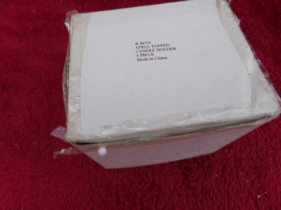 A candle in a ceramic jar. Apples on lid & side of jar. NEW IN BOX