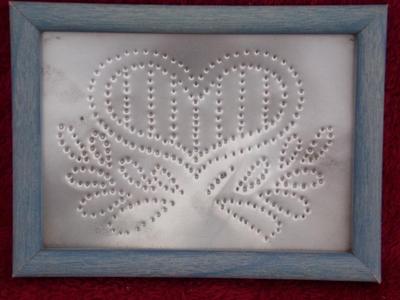 Metal art piece. Sheet metal punched pattern. About 6"x8" framed