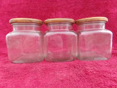 Three in a row! Square glass canisters. wooden lids with . . . .