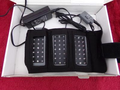 “dpl” pain relief belt w/LED lights. Uses LED light to relive pain.