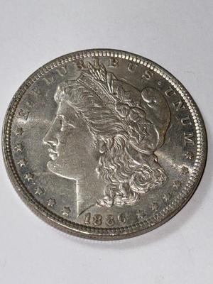 1886 AU CONDITION MORGAN SILVER DOLLAR AS PICTURED.