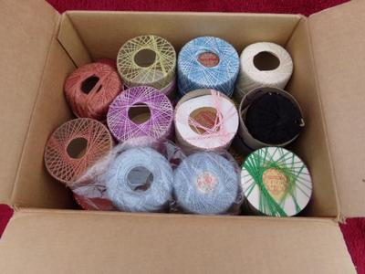 A box full of crochet thread. Lots of assorted colors & types.