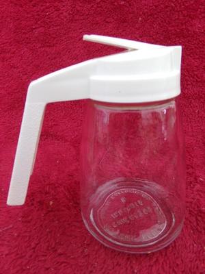 Group of 4 pancake/waffle syrup carafes of various sizes & styles.