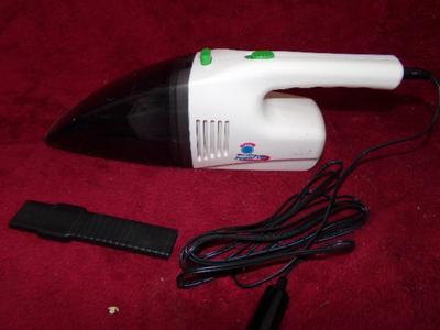 Hand held car vacuum cleaner. Plugs into cigar lighter port. Looks OKt try it.