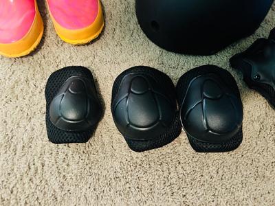 BOGS RAIN BOOTS AND CHILDREN'S HELMET KNEE PADS AND A SHOULDER PAD