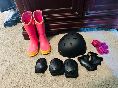 BOGS RAIN BOOTS AND CHILDREN'S HELMET KNEE PADS AND A SHOULDER PAD