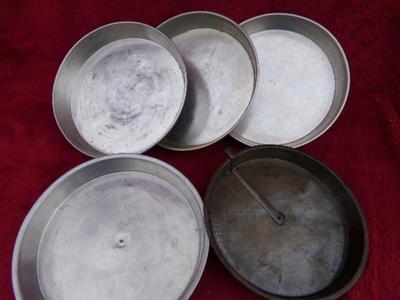 Group of 5 layer cake baking pans, 1 with release cutter.