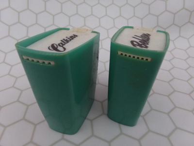Pair of spice shakers/containers. Look like promotional items. HANDY!
