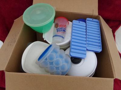 A pile of plastic kitchenware in a big box.