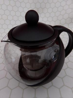 Glass Teapot w/infuser basket. Labeled 25 oz. Appears NEW IN BOX