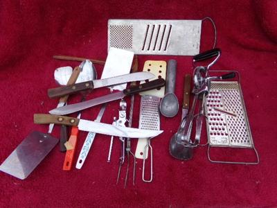 A bundle of kitchen tools and utensils in a box.