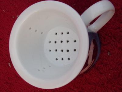 Cute little glazed ceramic cup w/matching steeper basket. Neat!!