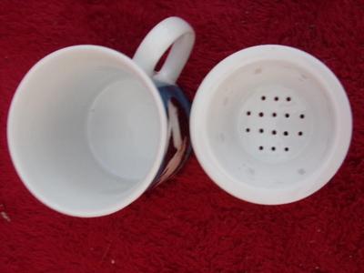 Cute little glazed ceramic cup w/matching steeper basket. Neat!!