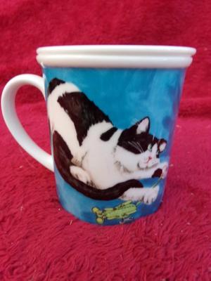 Cute little glazed ceramic cup w/matching steeper basket. Neat!!