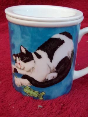 Cute little glazed ceramic cup w/matching steeper basket. Neat!!