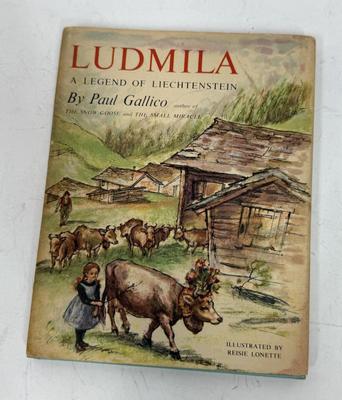 Sale Photo Thumbnail #439: Ludmila: A Legend of Liechtenstein is a 1954 children's book by Paul Gallico about a small cow named Ludmila who wants to win the Liechtenstein harvest ceremony's milk-production competition. The story is set in the Principality of Liechtenstein and featu