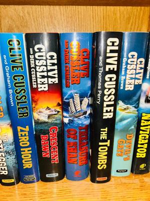 A COLLECTION OF CLIVE CUSSLER, DAVID BALDACCI AND OTHER HARD BACK NOVELS