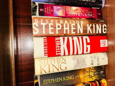 A HORRIFYING YET DELIGHTFULLY LARGE ASSORTMENT OF STEVEN KING AND DEAN KOONTZ BOOKS