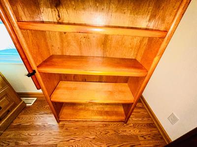 A LARGE OAK BOOKCASE WITH FLAG POLE