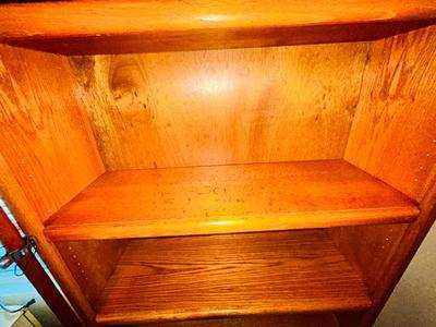 A LARGE OAK BOOKCASE WITH FLAG POLE