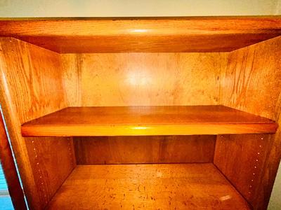 A LARGE OAK BOOKCASE WITH FLAG POLE
